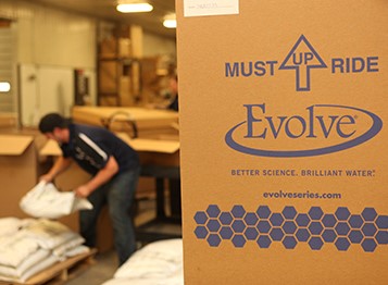 Evolve box with employee in background