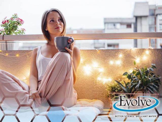 young woman with coffee mug on balcony